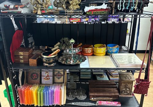 Shelves with candles, jewelry, incense, and other decorative items.